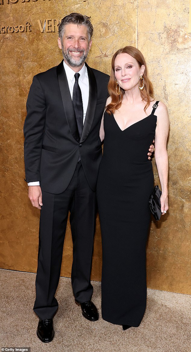Stunning: Julianne Moore, 62, put on a busty display in floor length black gown alongside her husband as she attended the Clooney Foundation for Justice’s second annual Albie Awards at New York's Public Library on Thursday night